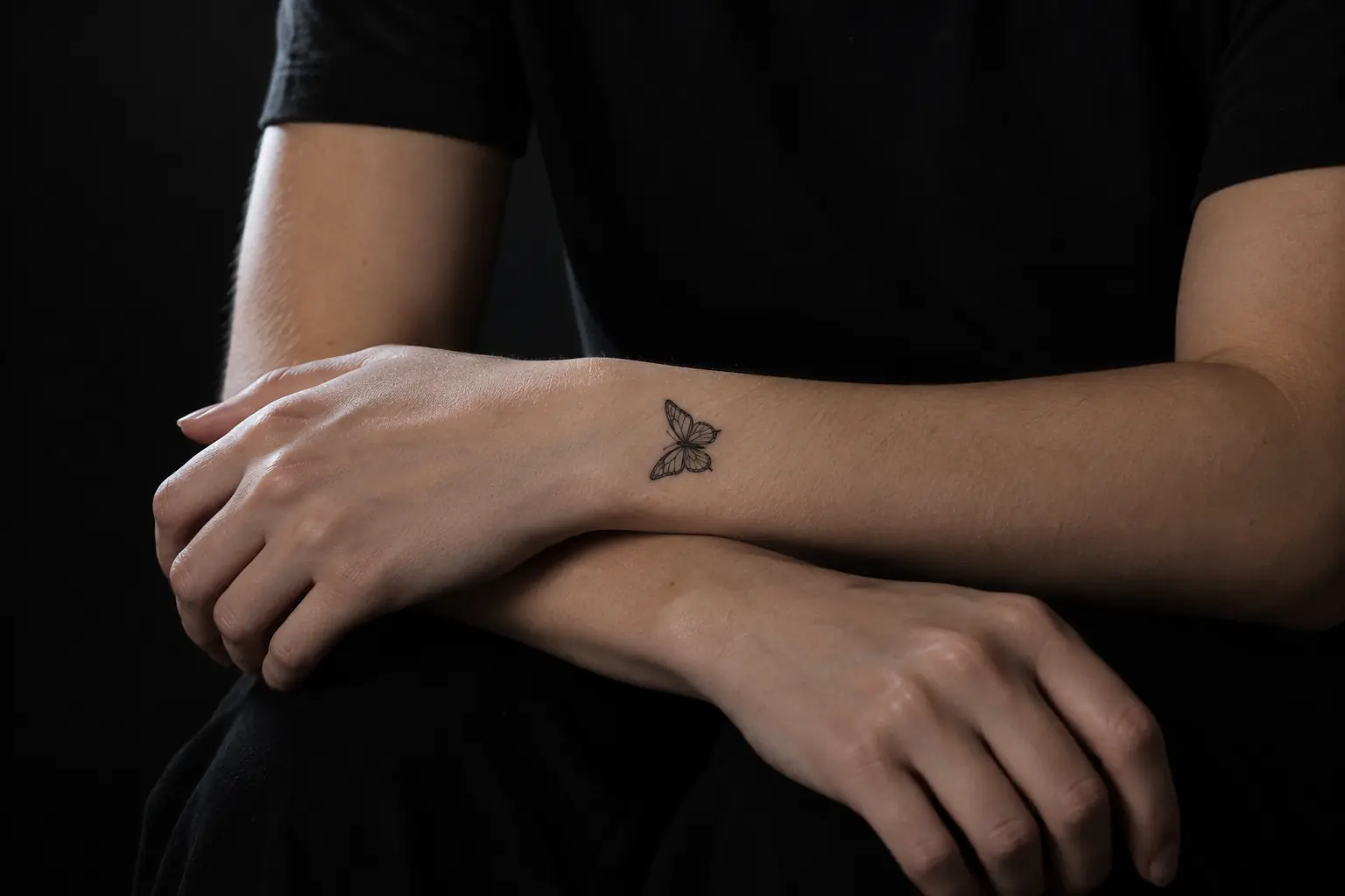 A butterfly temporary tattoo on the inside of a wrist